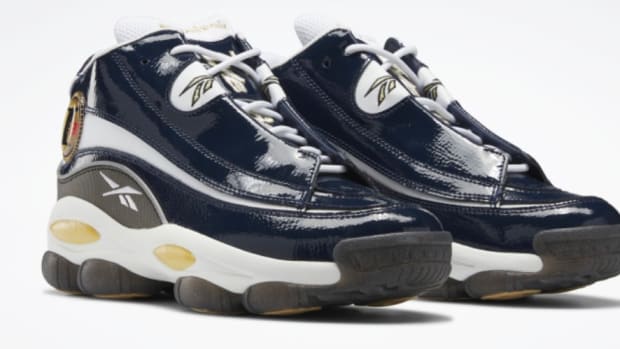 View of navy and white Reebok shoes.
